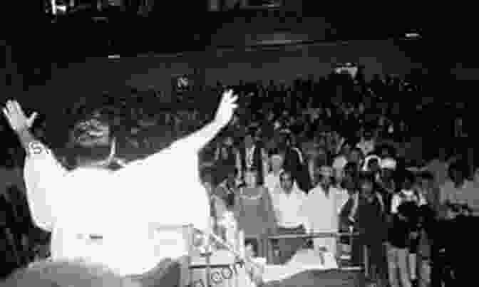 A Black And White Image Of Jim Jones Addressing A Crowd Of People's Temple Followers In Jonestown. A Thousand Lives: The Untold Story Of Hope Deception And Survival At Jonestown