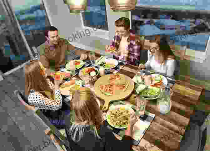 A Family Sitting Around A Table, Laughing And Eating Together The Family Dinner: Great Ways To Connect With Your Kids One Meal At A Time